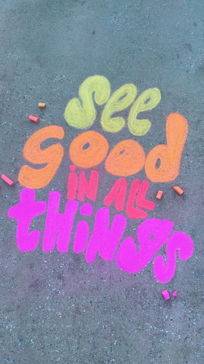 the words see good in all things are written on the ground with crayons