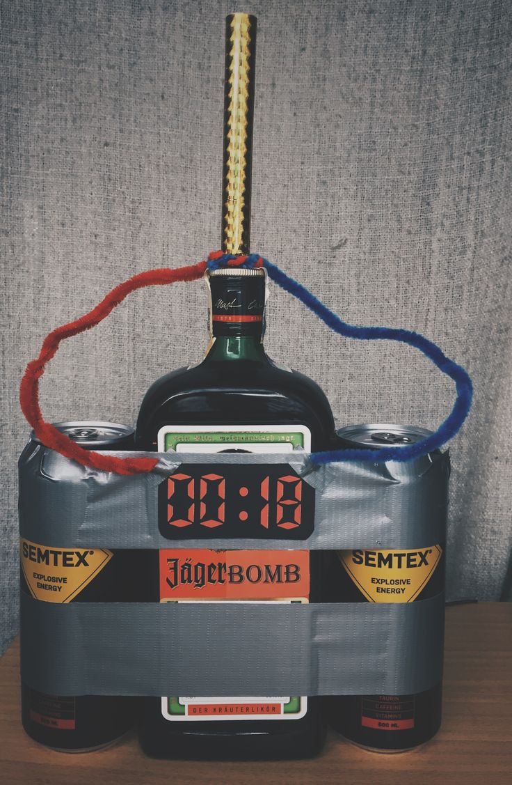 an alarm clock on top of a liquor bottle