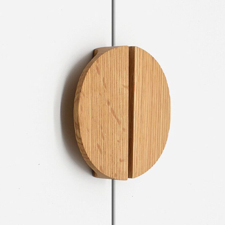 a wooden object mounted to the side of a white wall