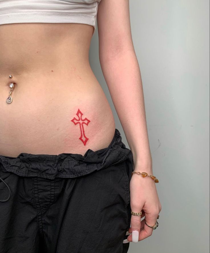 a woman with a cross tattoo on her stomach