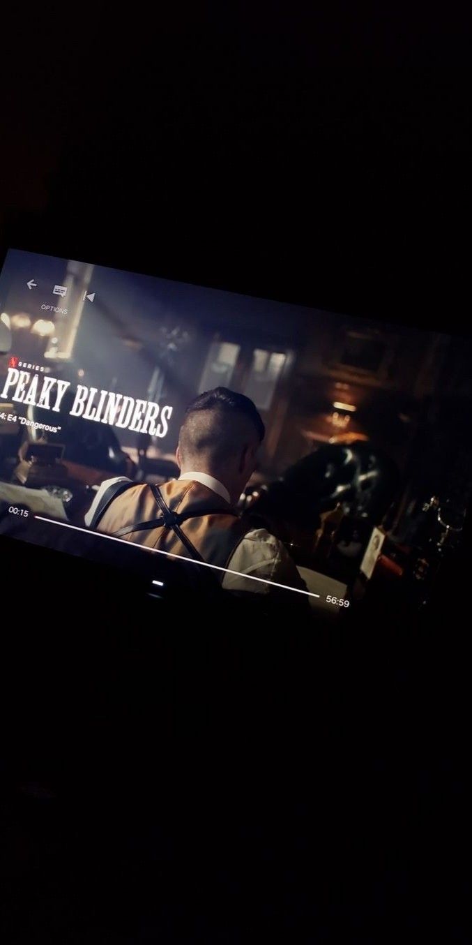 a television screen with the words peaky bluders on it in front of a dark background