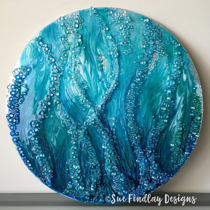 a blue plate with bubbles on it sitting on top of a counter next to a white wall