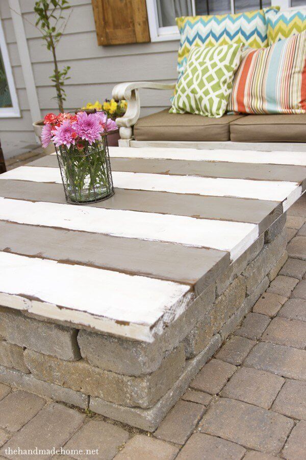 a table with flowers on it in front of a house