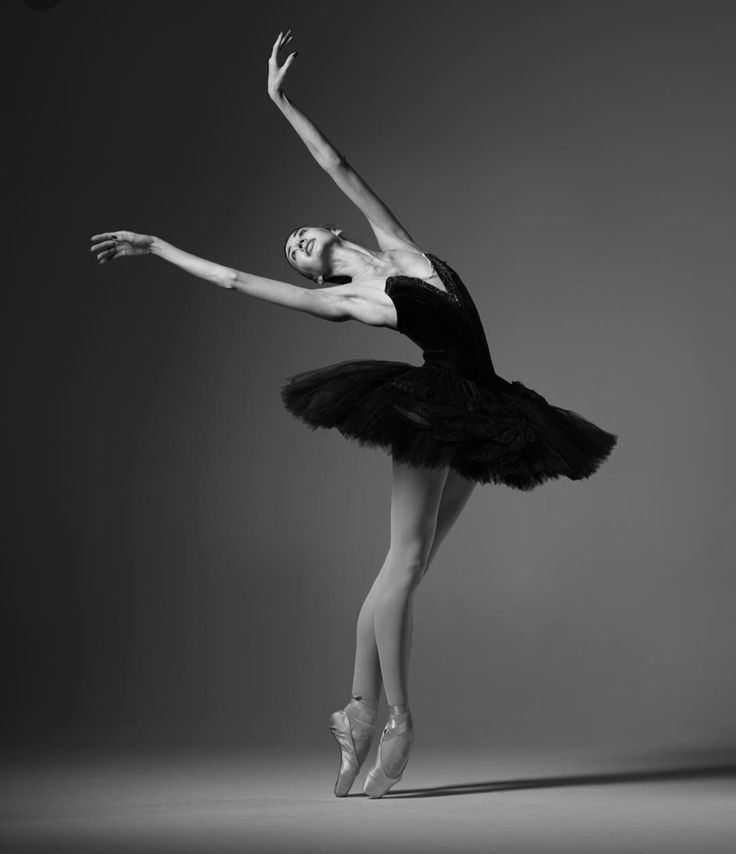 a ballerina in black and white poses for the camera