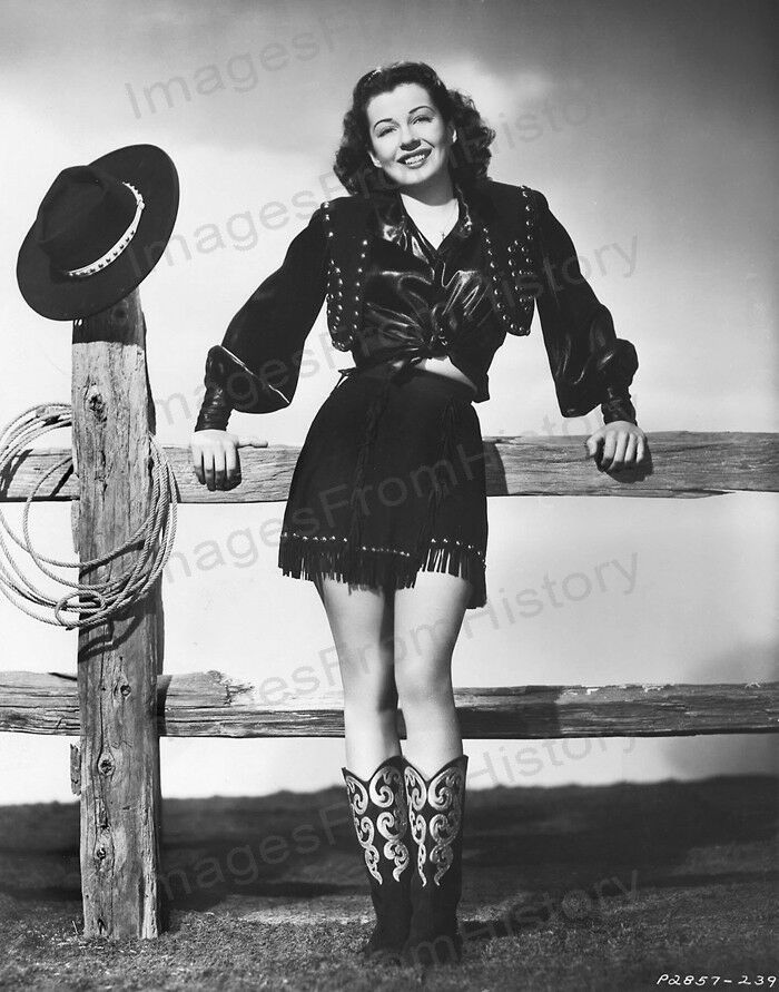 an old black and white photo of a woman wearing cowboy boots