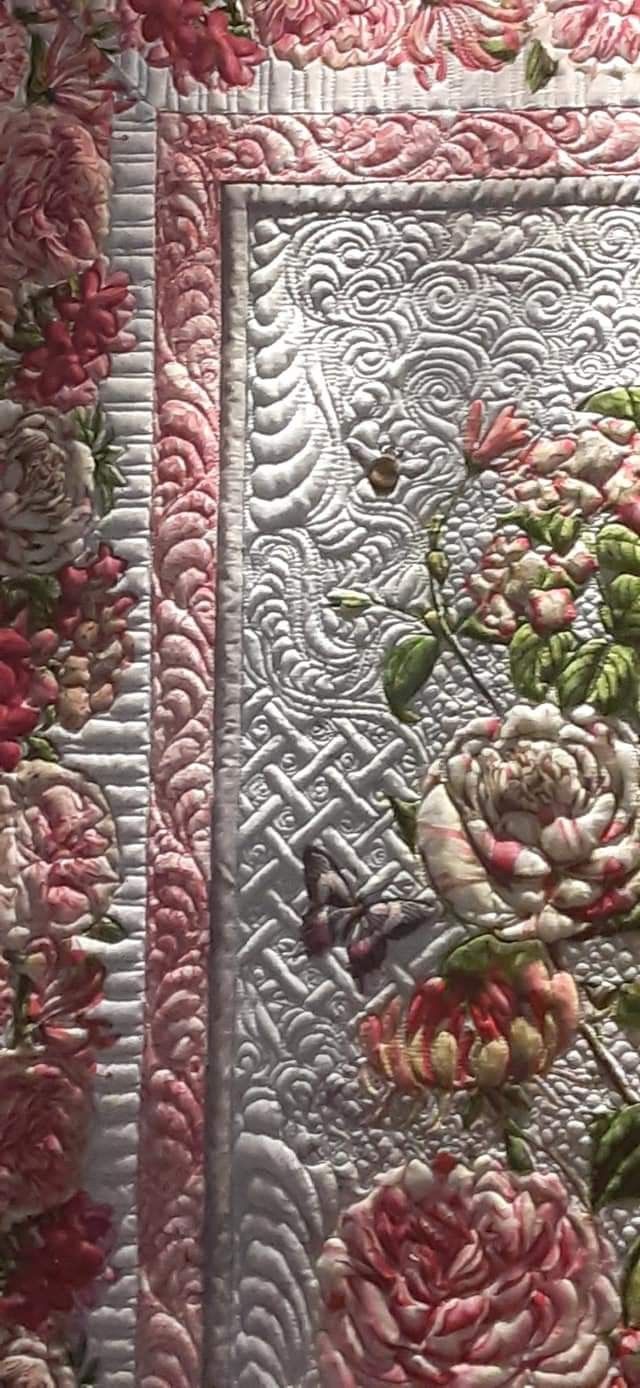 two quilts with pink flowers on them