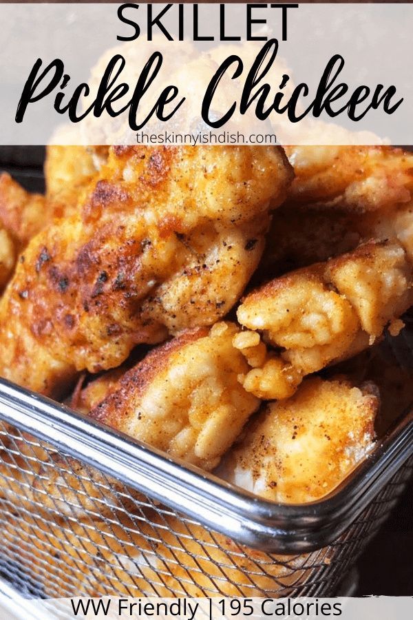 a basket filled with fried chicken sitting on top of a table