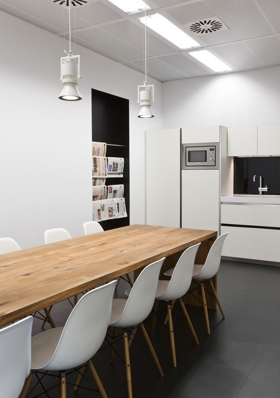 a kitchen and dining room with white chairs