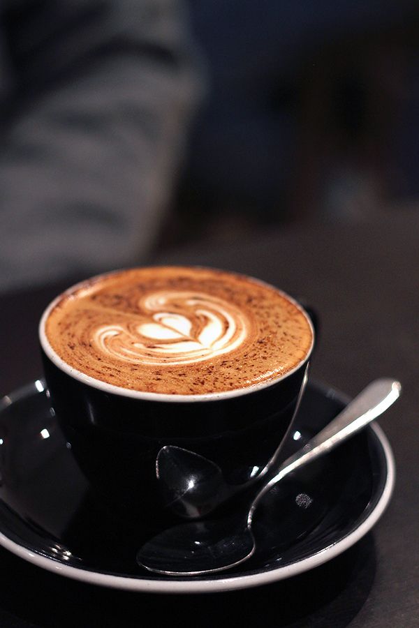 a cappuccino on a saucer with spoons