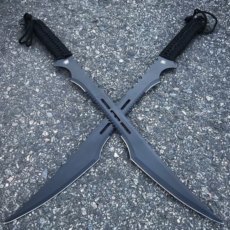 two knives are laying on the ground with their handles still attached to each others blades