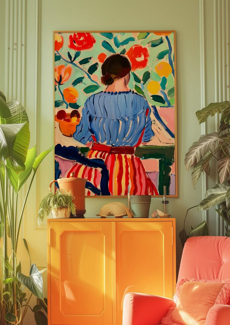 a painting on the wall above a yellow cabinet in a room with orange chairs and potted plants