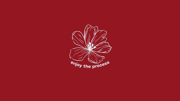 a red flower with the words enjoy the process written in white ink on a red background