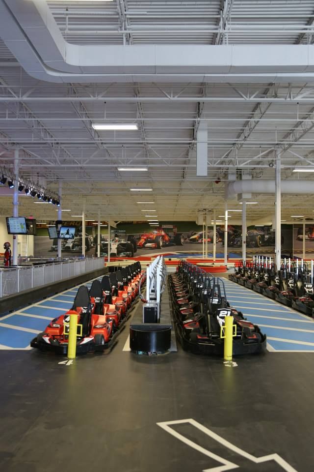 an airport filled with lots of empty seats and machines on the side of the road