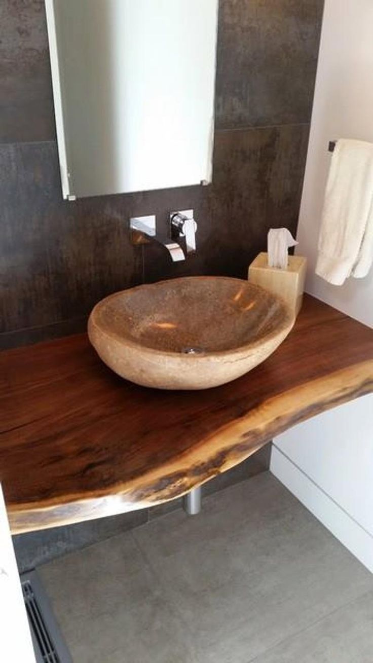 a bathroom with a wooden sink and mirror