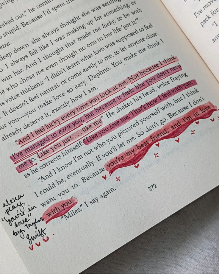 an open book with writing on it and red marker marks in the page next to it