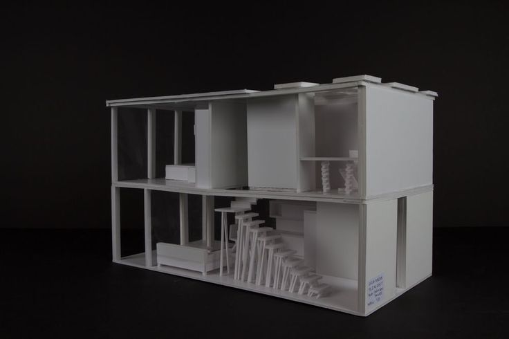 an architectural model of a house on a black surface with only the windows and doors open