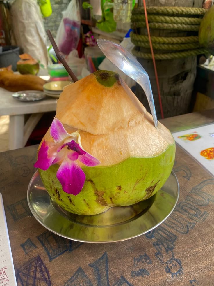 a green bowl filled with food on top of a metal plate