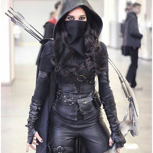 a woman dressed in leather and wearing a hood