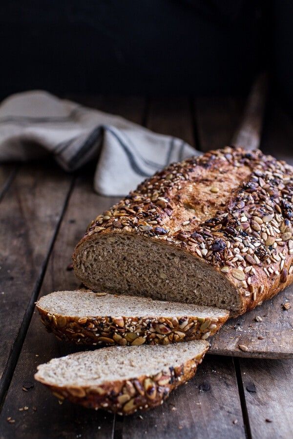 a loaf of bread sitting on top of a wooden cutting board