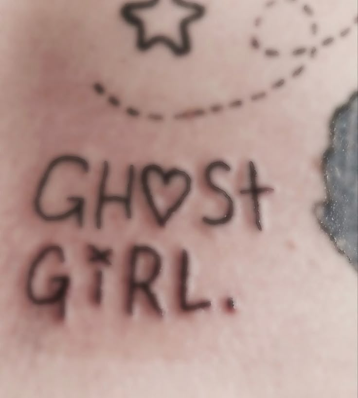 the word ghost girl written in black ink on a woman's chest and back