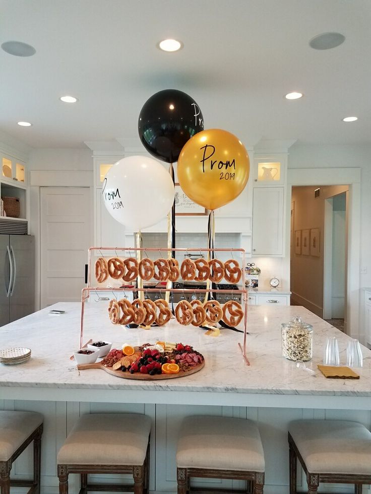 a kitchen island with balloons and pretzels on it for a birthday or bridal party