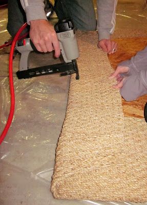 two people are sanding the floor with a machine