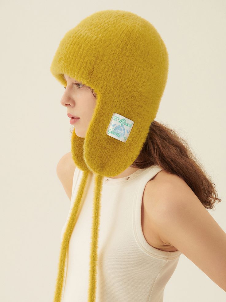 Editor's NoteGOCORI is a designer brand that unfolds collections through fashion aesthetics and beliefs that pursue the identity of a City Gardener, with a storytelling approach.- Trooper style hat- Made of warm angora and wool blended fabric- Artwork label patch at the ear flap- Self-tie straps attached- Cozy and adorable moodMeasurements(in.)One Size- Length: 13.78 in.- Wrist Width: 10.24 in.  Composition & Care- Material: 30% Angora, 20% Wool, 45% Acrylic, 5% Spandex- Dry clean only- Do not bleach- Do not twist- Do not tumble dryDesigner- by GOCORI Warm Winter Bonnet With Curved Brim, Adjustable Ear Flap Hat For Fall, Winter Wool Hat With Curved Brim, Adjustable Fall Hat With Ear Flaps, Adjustable Ear Flaps Hat For Fall, Vintage Fur Felt Hat For Winter, Adjustable Wool Hat For Winter, Wool Hat With Ear Flaps For Winter, Wool Hat With Short Brim For Winter