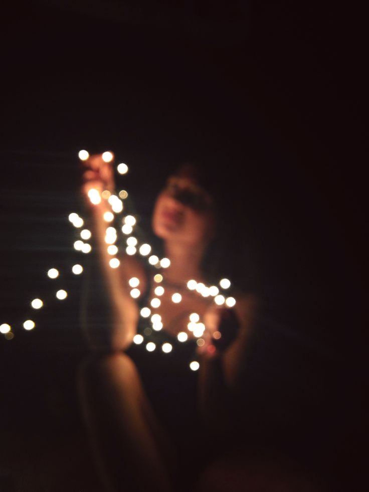 a woman is holding some lights in her hand