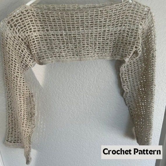 a knitted sweater hanging up on a wall with the words crochet pattern below it