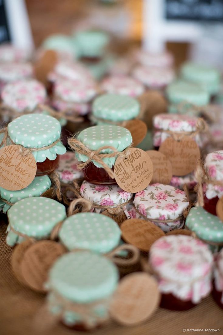 many small hearts are sitting on a table with tags attached to the heart shaped buttons