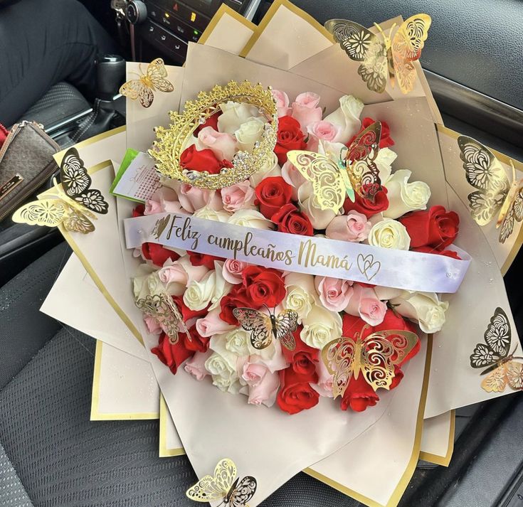 a bouquet of roses and butterflies is on display in the back seat of a car