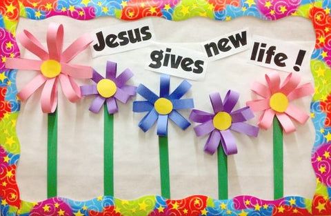 a bulletin board with paper flowers and the words jesus gives new life