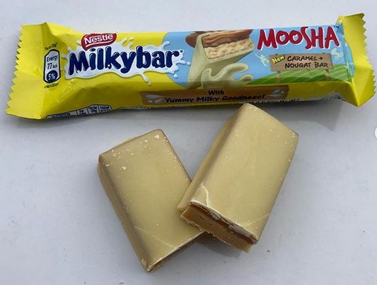 two bars of milk chocolate sitting next to each other on a white counter top,