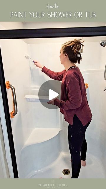 a woman is painting the shower or tub