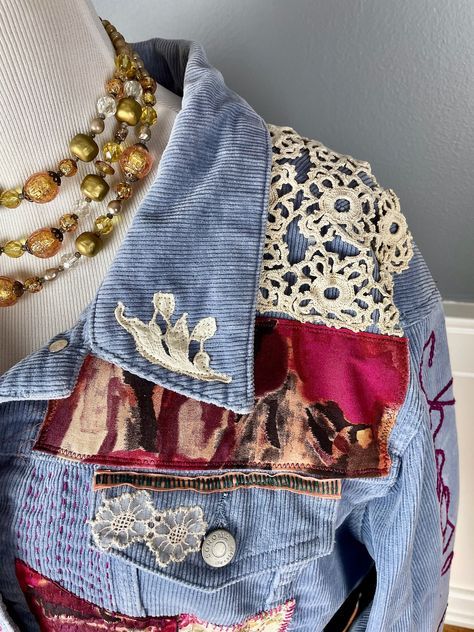 a close up of a jacket on a mannequin's head with beads