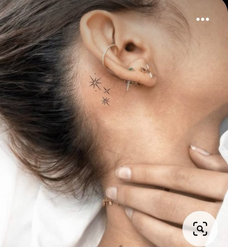 a woman with tattoos on her ear and behind her ear is the words 15 idees de tatouages discreets reprefs sur pinterest