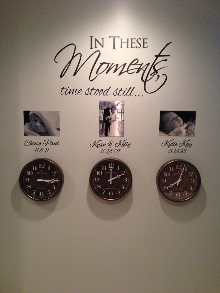 three clocks are hanging on the wall in front of a sign that says in these moments time stood still