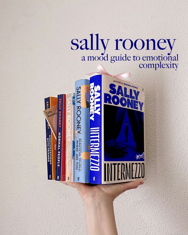 a hand holding a stack of books in front of a white wall with the words salty roney on it