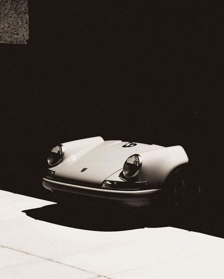 a black and white photo of a porsche type car