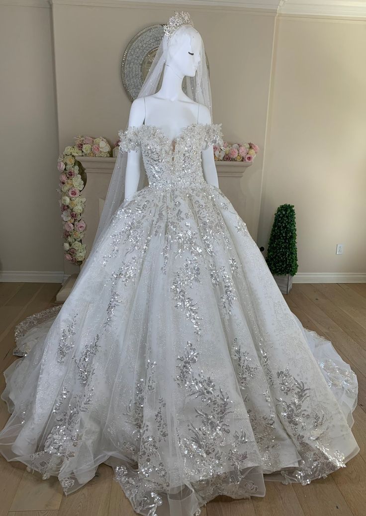 a white wedding dress on display in a room