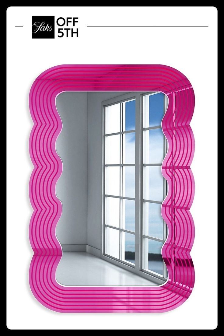 a pink mirror sitting on top of a white wall next to a window with an open window