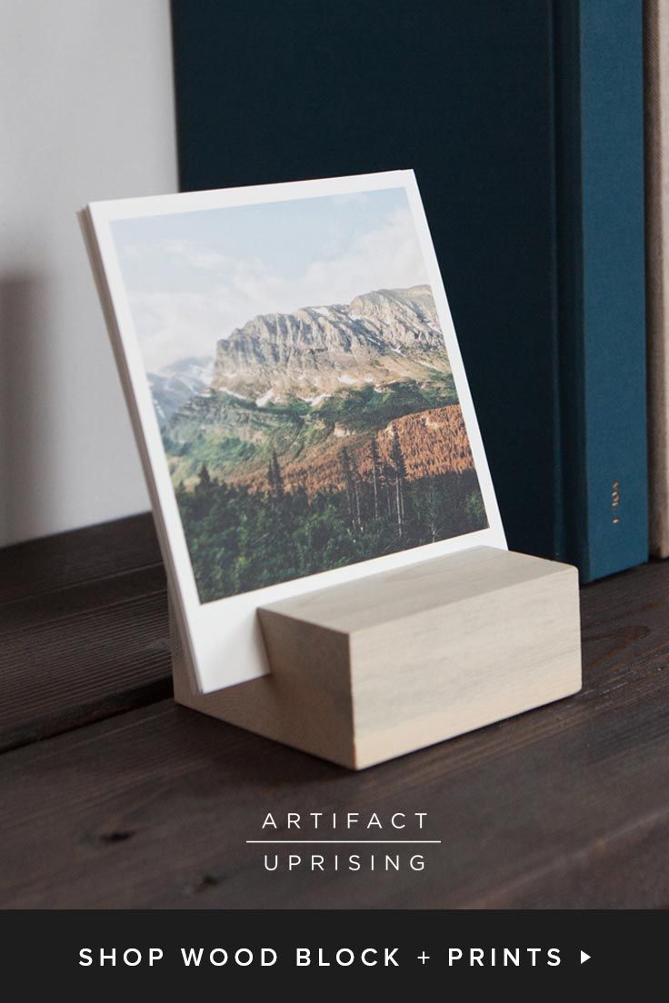 a wooden block with a photo on it next to two books and an open book