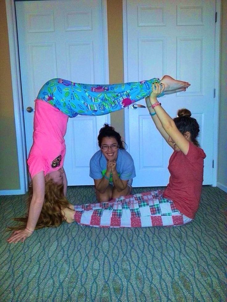 three girls are playing with each other on the floor