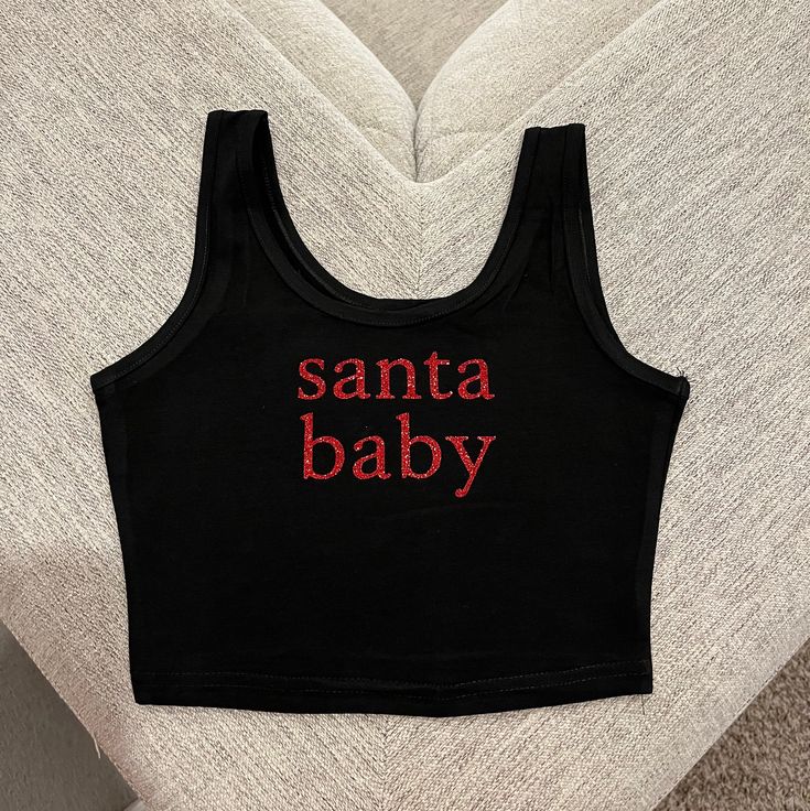 Super cute Santa baby crop top perfect for Christmas time and for cute family pijama pictures 🎄❤️ * the glitter material on these crop tops is professionally pressed and does NOT fall* ** DISCLAIMER these tops run a bit small so please size up if in doubt ! ** Trendy Winter Cotton Crop Top, Trendy Cotton Winter Crop Top, Trendy Cotton Crop Top For Winter, Cute Crew Neck Tank Top With Letter Print, Cute Red Party Top, Cute Red Holiday Tops, Cotton Crop Top For Winter Loungewear, Fitted Trendy Tops For Holiday, Trendy Fitted Tops For Holiday