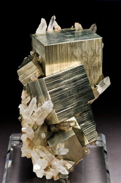 a piece of glass sitting on top of a wooden block with rocks in the middle