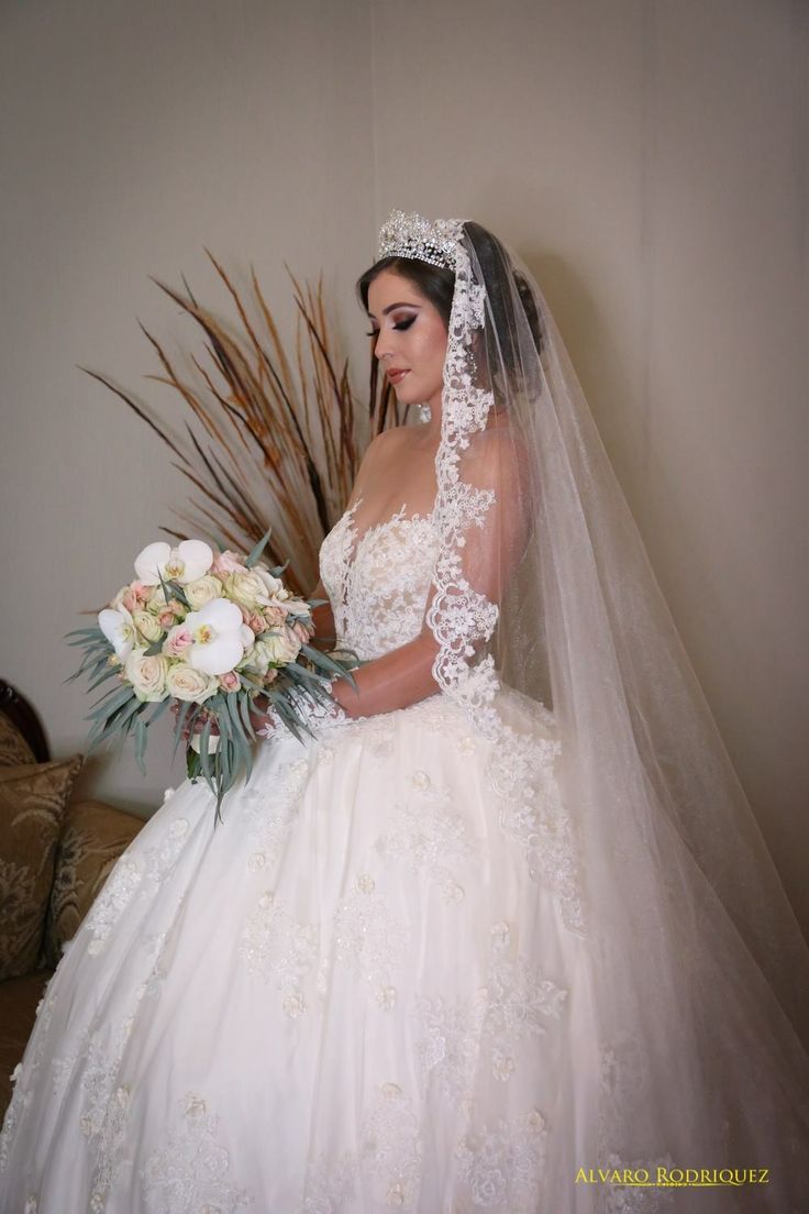 a woman in a wedding dress holding a bouquet