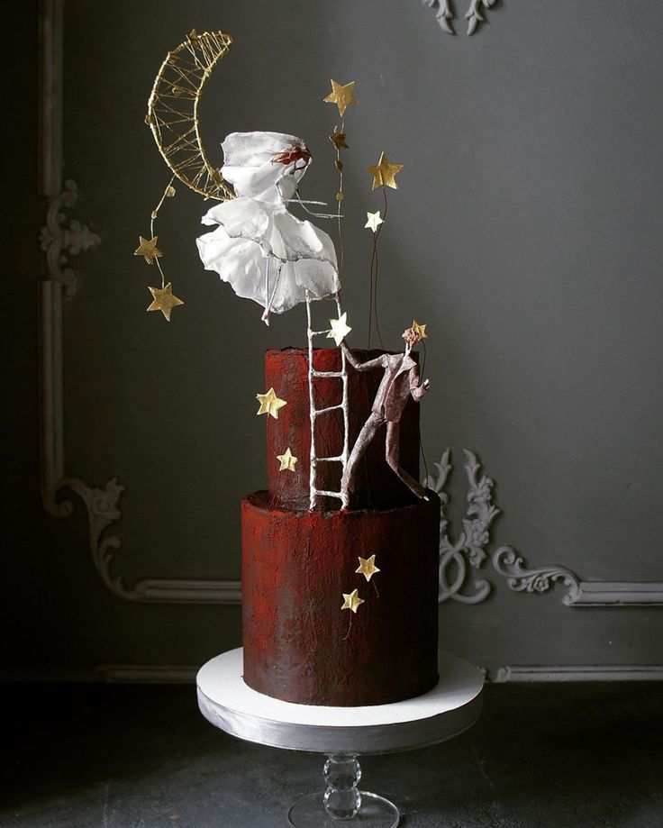 a red and white cake with gold stars on top