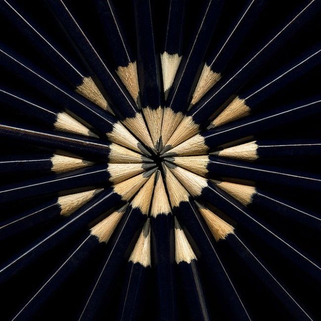 black and white photograph of pencils arranged in the shape of a starburst