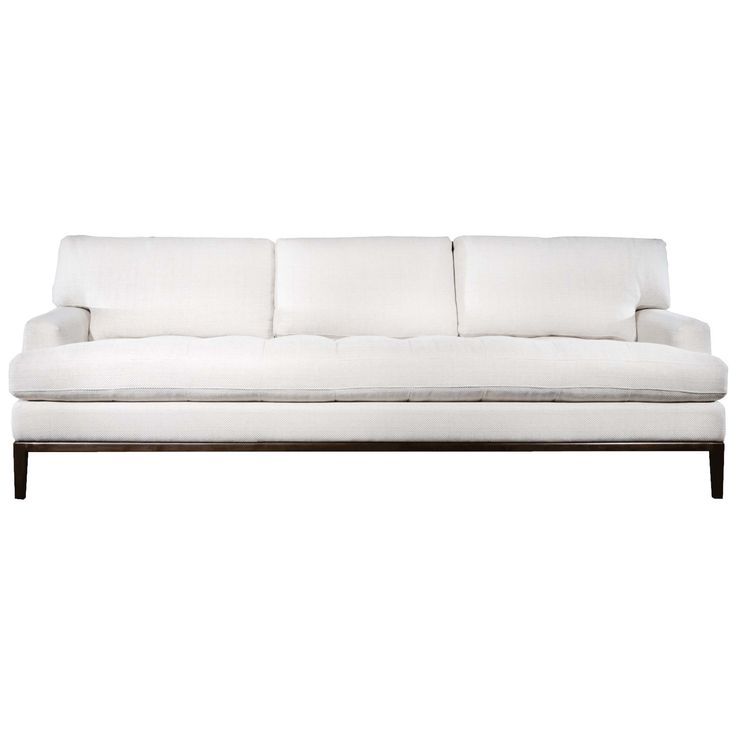 a white couch sitting on top of a wooden frame