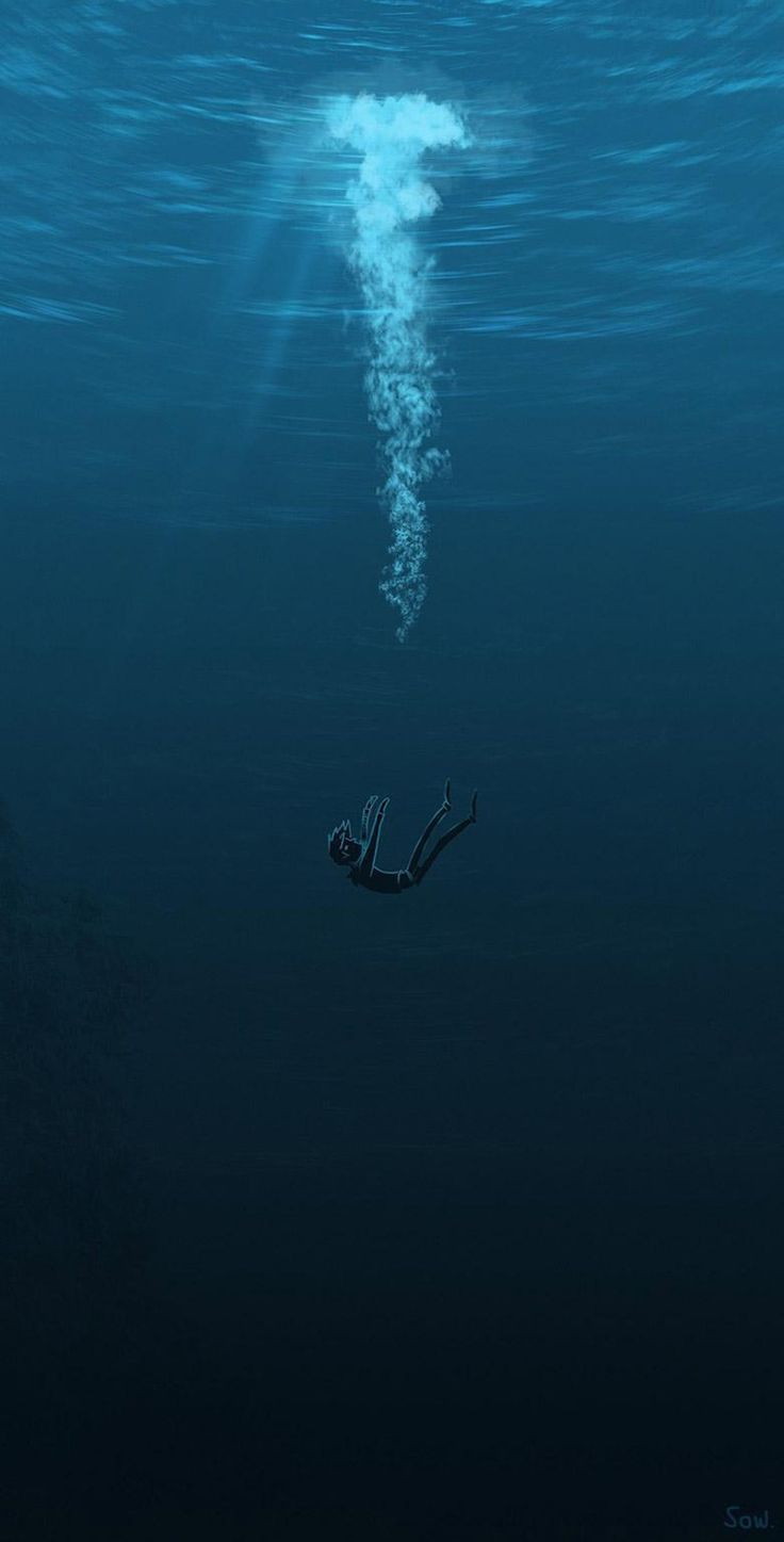 a person floating in the water with their hand up